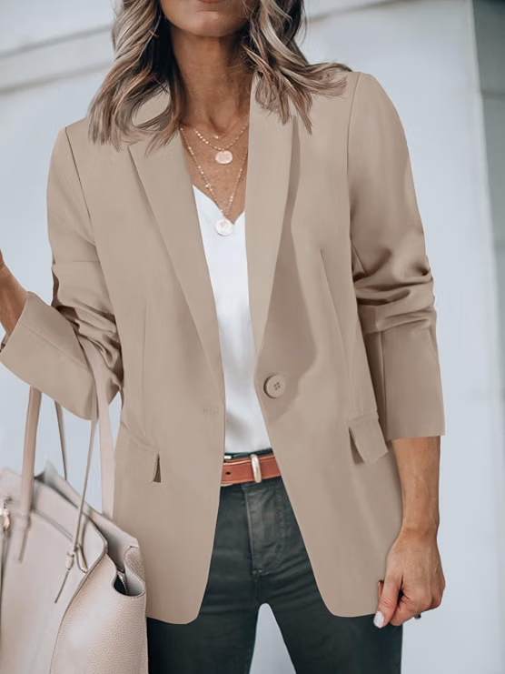 Beige tailored blazer worn over a light top